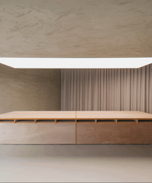 modular wooden table reforms into exhibition platform within ceramic workshop by AACM