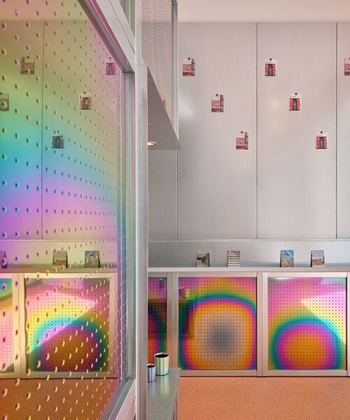 iridescent titanium panels cast chromatic reflections within info desk by KOGAA in brno